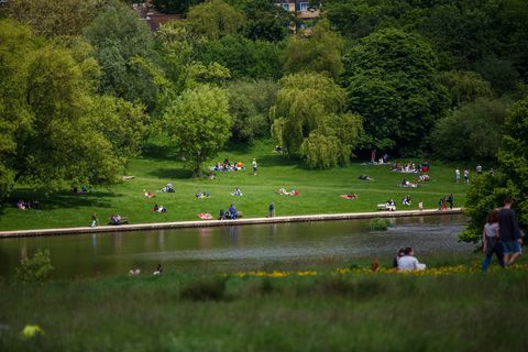 Местните жители и туристите, наслаждаващи се на времето в Hampstead Heath, Лондон